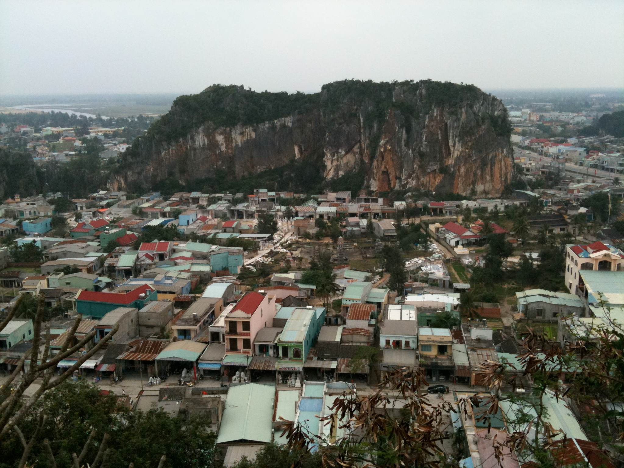 Looking down from Thủy Sơn over rooftops to a neighbouring marble peak
